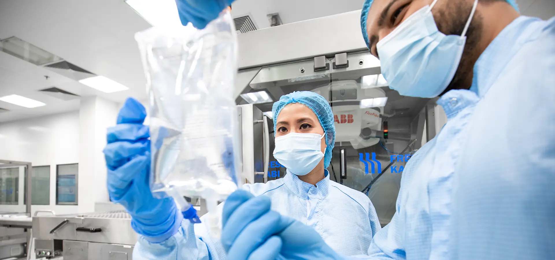 Two nurses inspecting infusion bag in operating room (Photo)