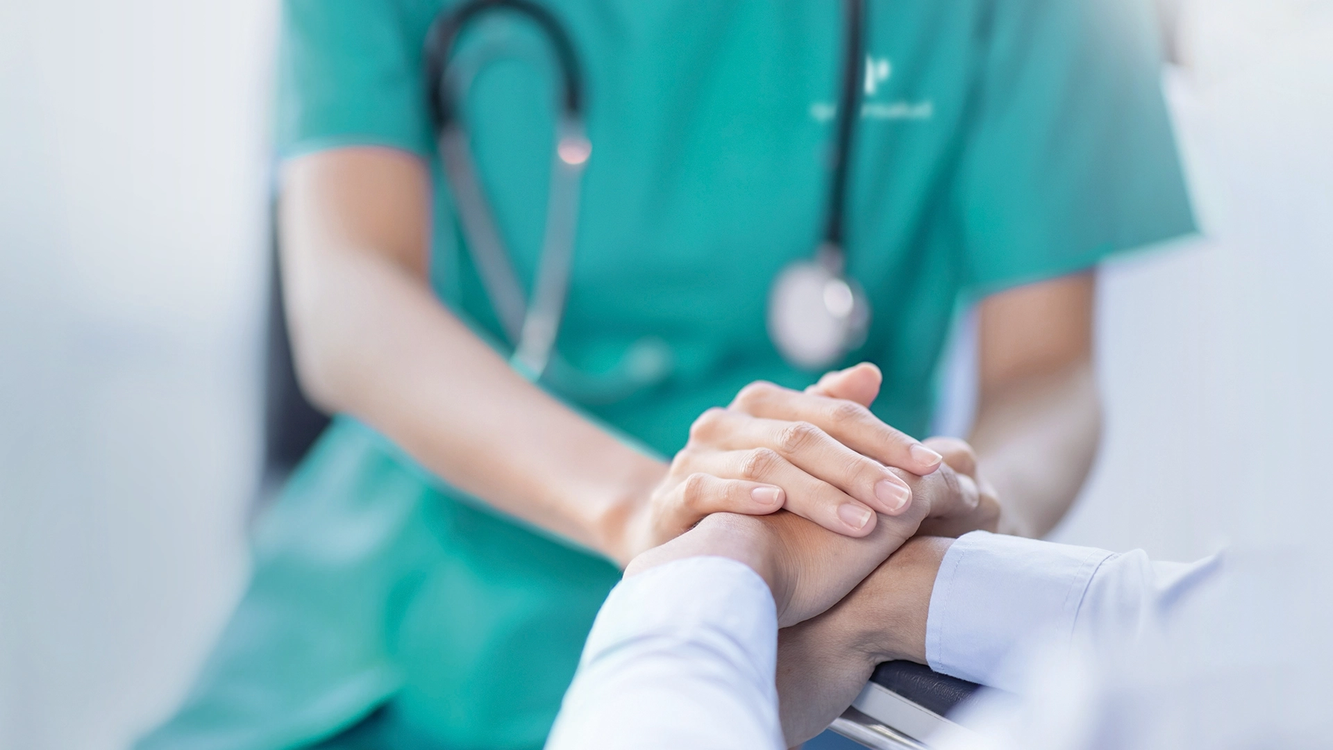 Close-up of a doctor holding a patients hands (Photo)