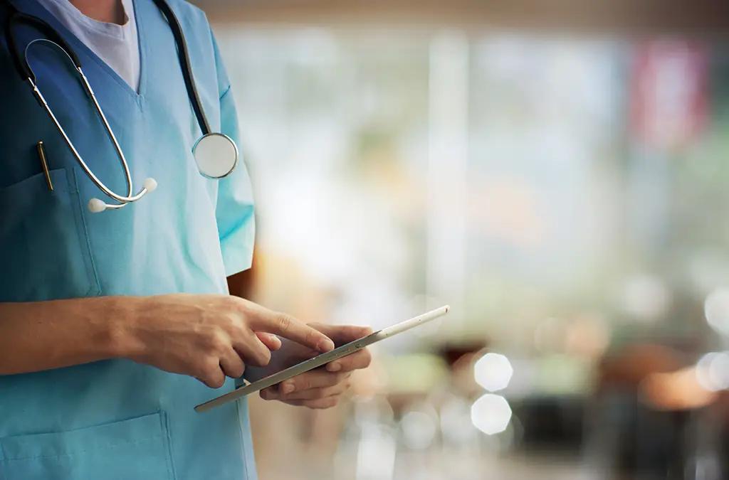 Close-up of a doctor with a tablet in hands (Photo)